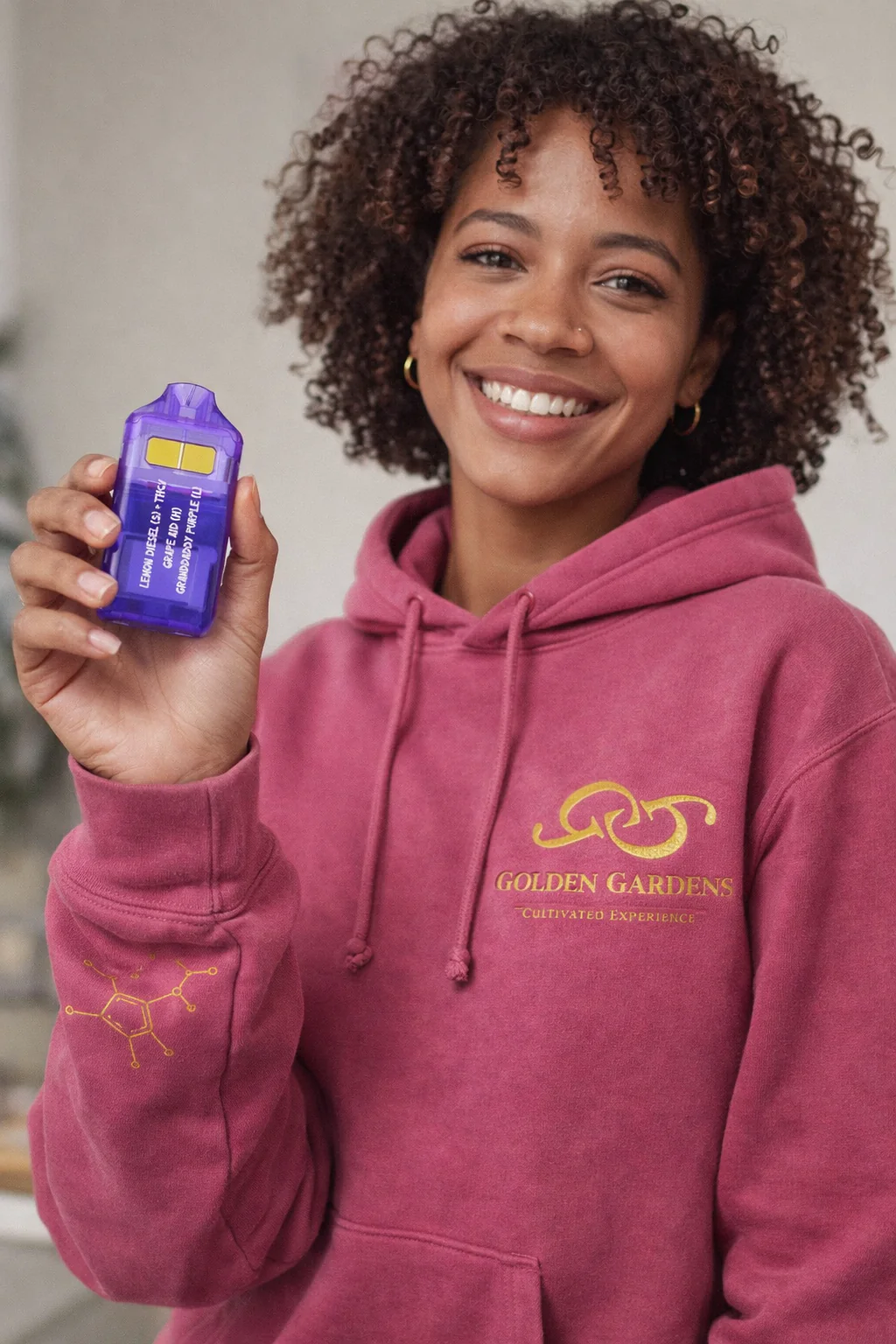 Women holding two chamber, dual chamber vaporizer from Golden Gardens. Granddaddy, purple Indica and one chamber, and the other chamber is lemon diesel sativa.