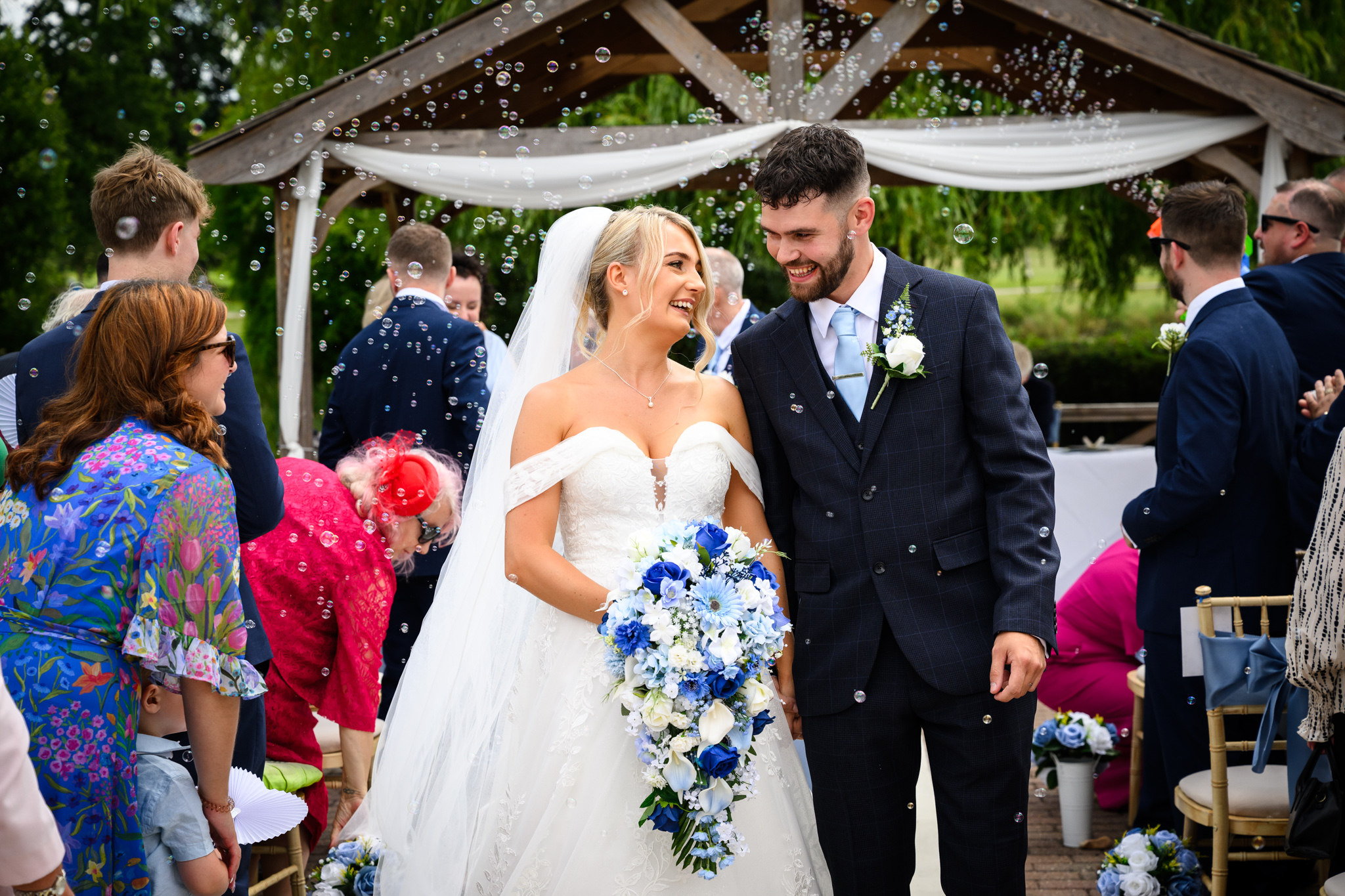 Bride and groom confetti photo at Reigate Hill Golf club. Captured by relaxed Sussex wedding photographer Paul Streeter-Staniford